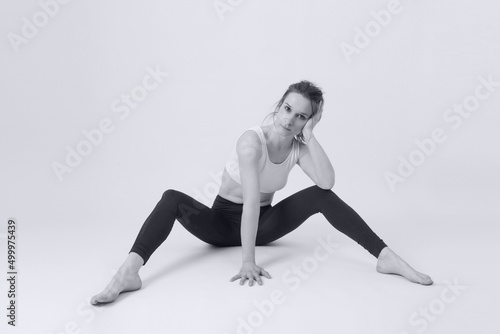 Portrait of healthy young woman in leggings and sport bra before training. © triocean