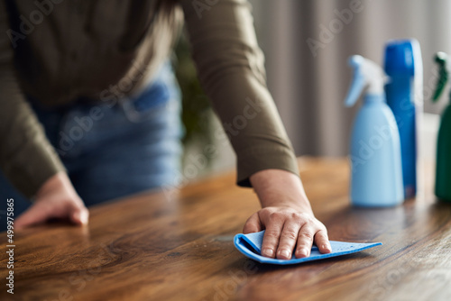Close up of caucasian woman cleaning table at home