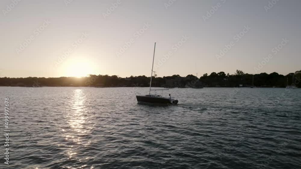 Idyllic View Of A Sailing Boat During Sunset In Summer. Wide Shot Idyllic View Of A Sailing Boat During Sunset In Summer. Wide Shot