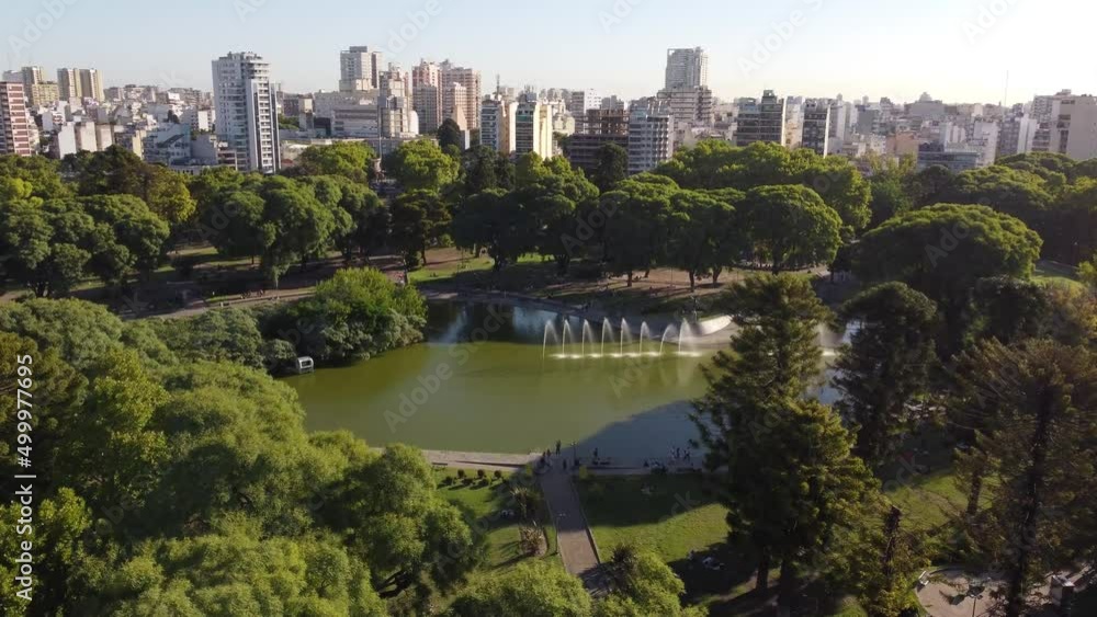 People at Centenario public park lake with Buenos Aires cityscape skyline in background. Aerial People at Centenario public park lake with Buenos Aires cityscape skyline in background. Aerial