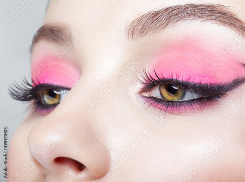 Closeup macro shot of human female face with pink makeup