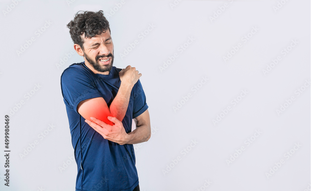 Concept of a man with rheumatism elbow pain, man massaging sore elbow, man with elbow cramp, Person with elbow pain Concept of a man with rheumatism elbow pain, man massaging sore elbow, man with elbow cramp, Person with elbow pain