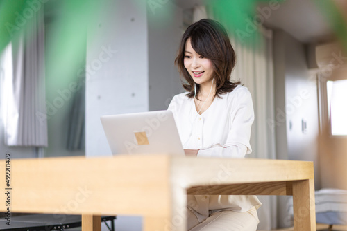 A young career woman telecommuting to an online meeting
