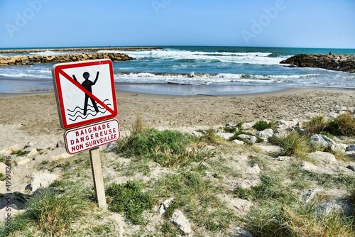 no swimming sign, photo as a background , in saint maries de la mer sea village Camargue, france