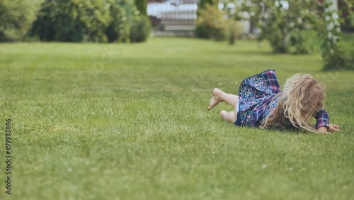 A girl is lying on the grass in the garden. photo