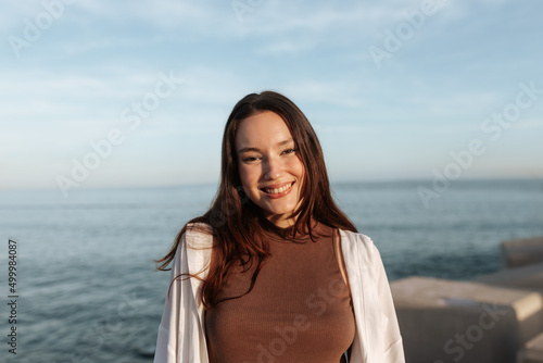 Pretty brunette woman smiling at the camera by the seaside © JLCo Ana Suanes