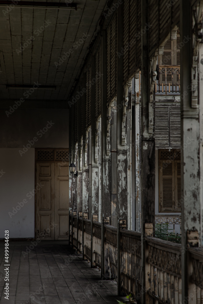 The corridor interior of ancient Thai style house from teak wood. Architecture of old wooden building of the historical nonthaburi city Hall, Selective focus at Antique black lamp.
