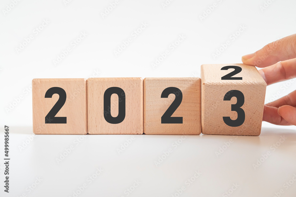 Hand translated wooden cube from 2022 to 2023.new business goal