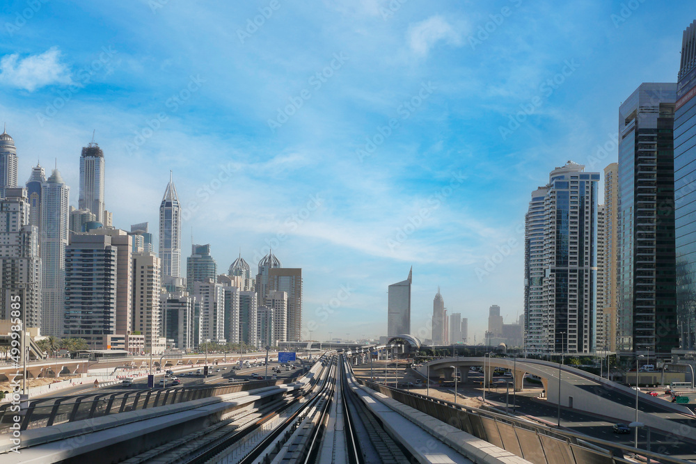 Dubai metro railway in downtown district with buildings and skyscrapers. United Arab Emirates. Panoramic view