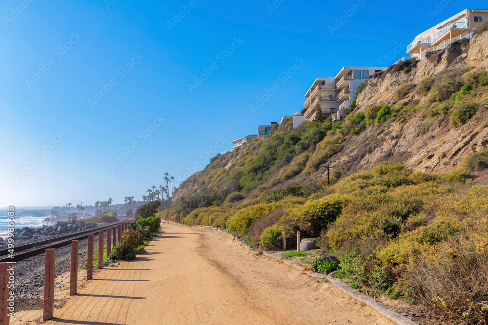 Dirt road with wooden post barrier near the train track in San Clemente, California