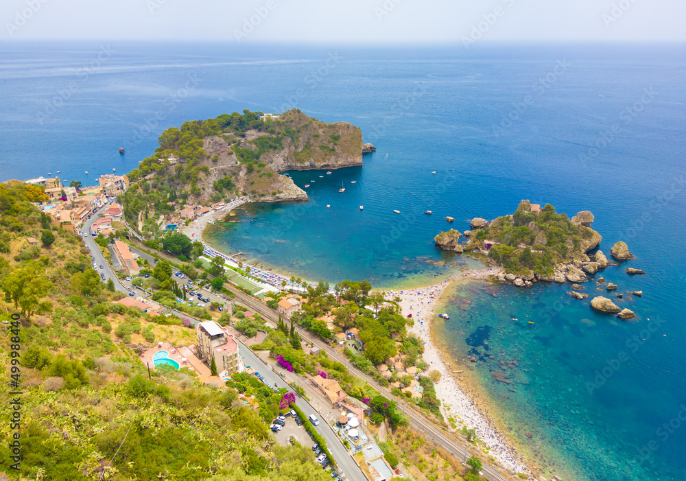 Taormina (Sicilia, Italy) - A historical center view of the touristic city in province of Messina, Sicily island, during the summer, famous for Isola Bella beach and the old theatre Taormina (Sicilia, Italy) - A historical center view of the touristic city in province of Messina, Sicily island, during the summer, famous for Isola Bella beach and the old theatre