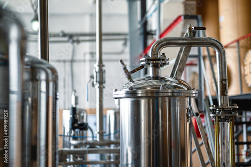 Stainless tanks with pipelines installed in processing shop