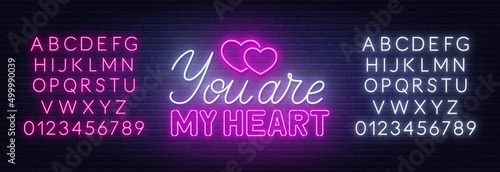 You are my heart neon lettering on brick wall background.