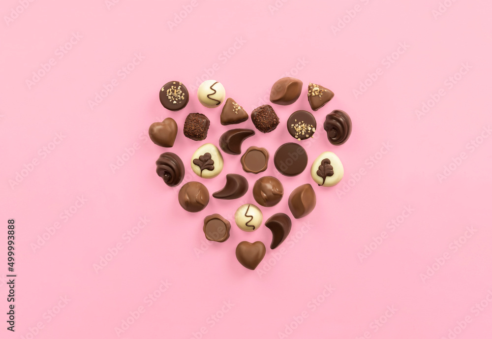 heart made of chocolates on pink background heart made of chocolates on pink background