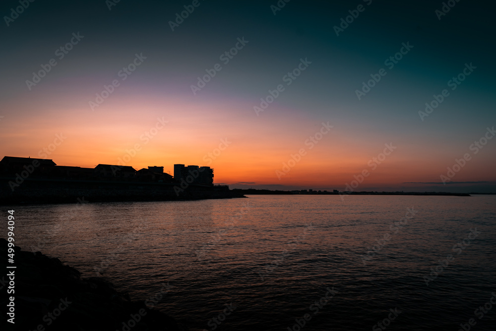 sunset over the sea and city
