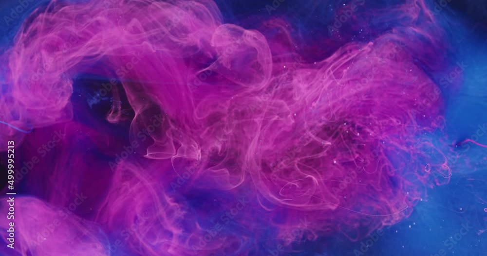 Paint mix in water. Color dye explosion. Logo reveal effect. Neon pink blue liquid ink splash on bright glitter mist texture abstract art background shot on Red Cinema camera 6k. Paint mix in water. Color dye explosion. Logo reveal effect. Neon pink blue liquid ink splash on bright glitter mist texture abstract art background shot on Red Cinema camera 6k.