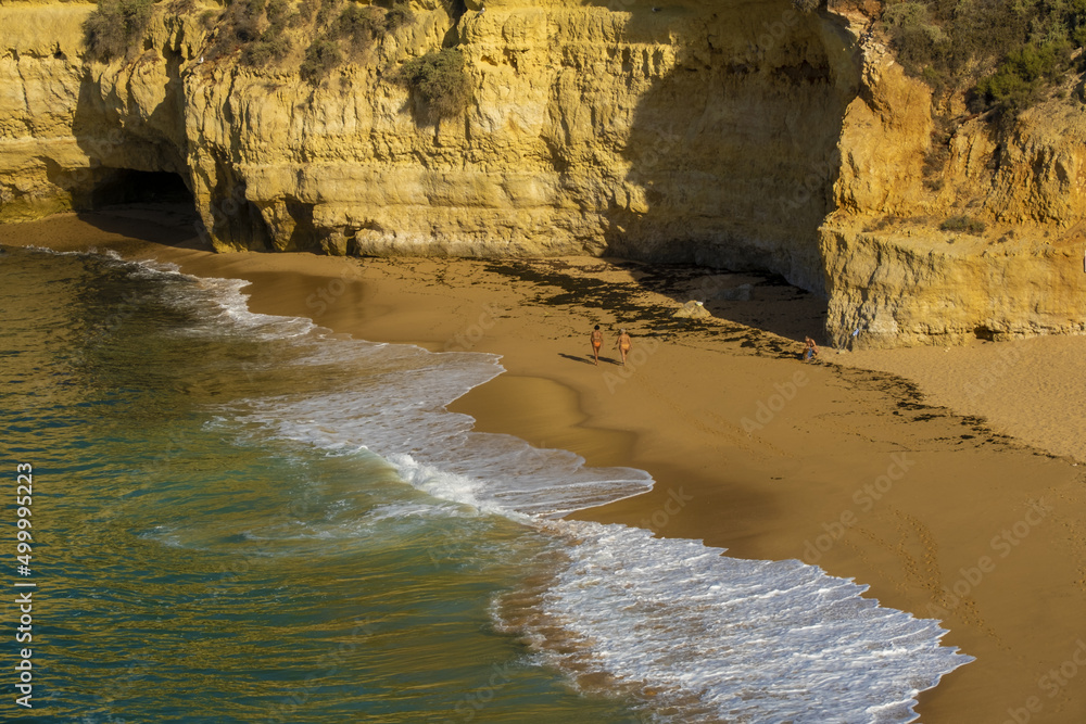 waves on the Carvoeiro Sandy beach of Carvoeiro between cliffs and rocks, Algarve, Portugal waves on the Carvoeiro Sandy beach of Carvoeiro between cliffs and rocks, Algarve, Portugal