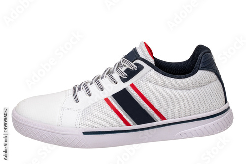White sneakers isolated. Close-up of a single white elegant stylish leather sport shoe isolated on a white background. Clipping path. Kids shoe fashion. Modern design footwear for workout. Macro.