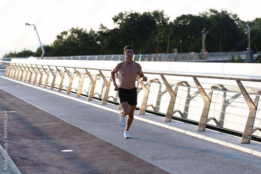 athletic man runner with muscular torso jogging
