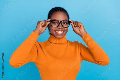 Photo of nice manager lady healthy eye correction concept wear eyewear orange pullover isolated blue color background