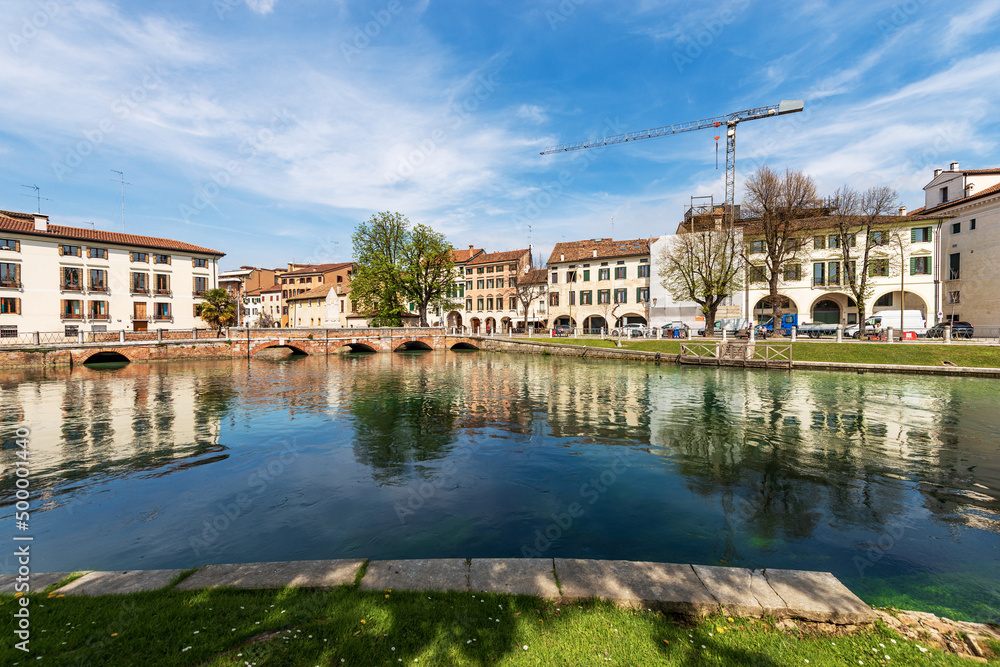 Cityscape of Treviso downtown with the river Sile with the street called Riviera Garibaldi and the small bridge called Ponte Dante. Veneto, Italy, Europe.