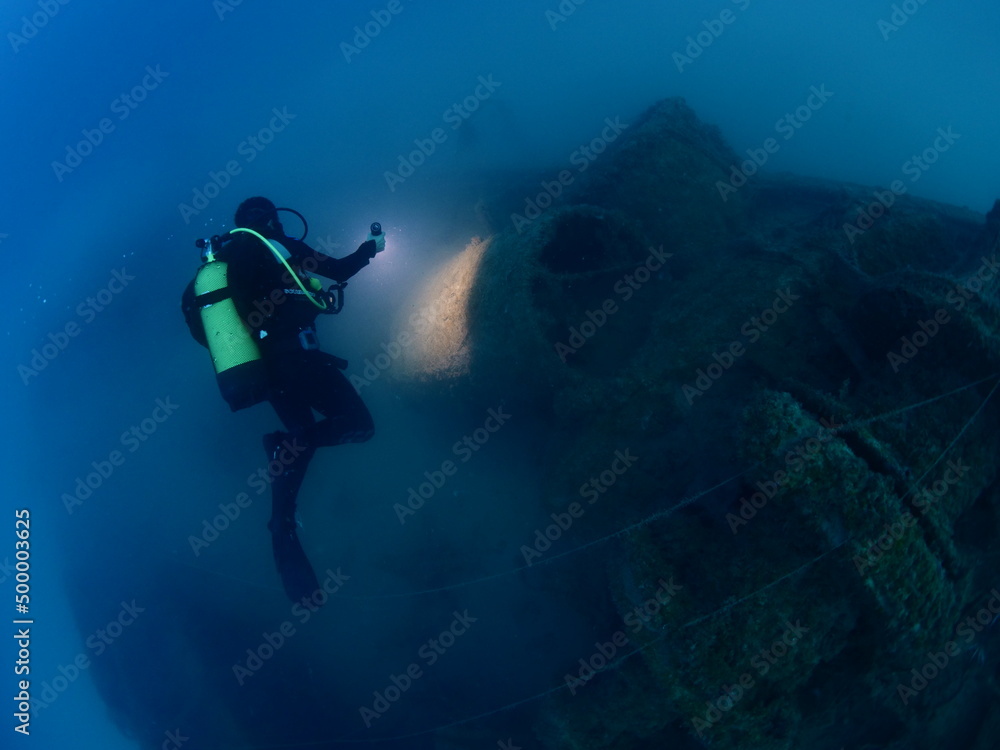 scuba divers exploring old ship wreck with torch light underwater from 1 world war ww1 wreck ocean scenery of history scuba divers exploring old ship wreck with torch light underwater from 1 world war ww1 wreck ocean scenery of history