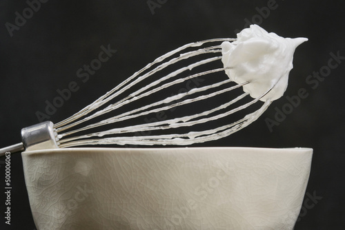 Whipping cream with a whisk. Shallow depth of field