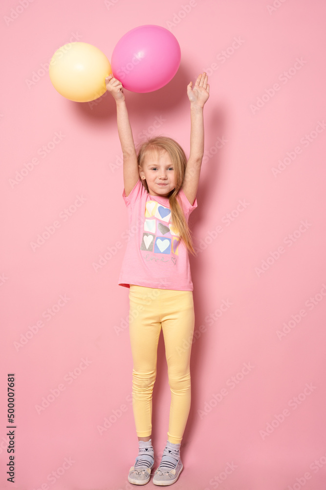 Pretty little girl with colorful balloons on pink background