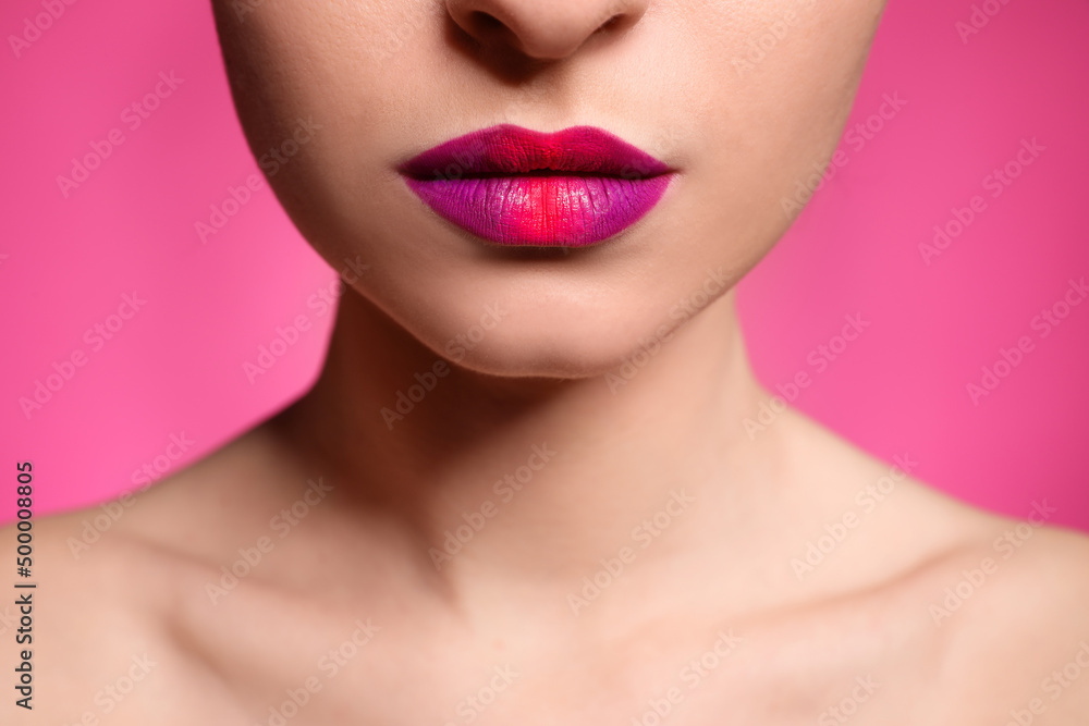 Young woman with beautiful lips makeup on pink background, closeup Young woman with beautiful lips makeup on pink background, closeup