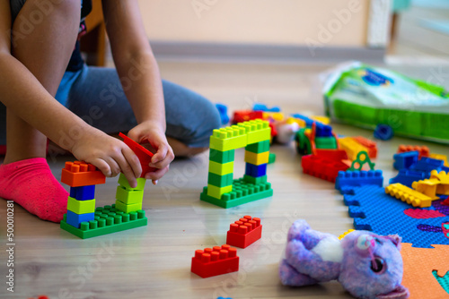 little girl playing with toys at home, Brickss type toys