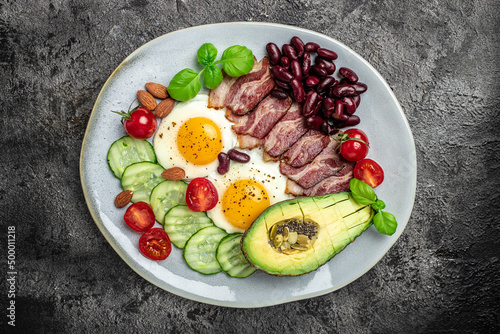 Ketogenic diet meal avocado, fried eggs, bacon, and beans. Healthy nutritious paleo keto breakfast diet lunch. banner, catering menu recipe place for text, top view