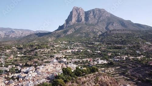 Aerial view of Finestrat village on Puig Campana mountain background. Orbit shot.