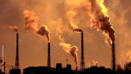 Environmental pollution by carcinogens of smoke from industrial pipes. Smoke from a factory chimney rises into the atmosphere.