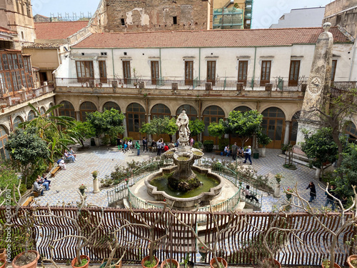 Palermo, Sicily, Italy - April 15, 2022: The majolica cloister with fountain in courtyard of the Santa Caterina church, Palermo, Italy. photo