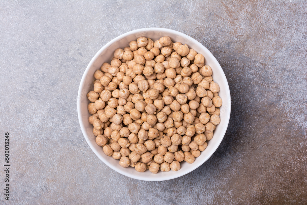 Uncooked chickpeas in white bowl Uncooked chickpeas in white bowl