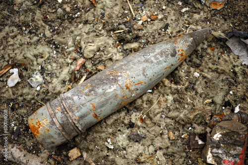 Close-up of artillery shell on the ground