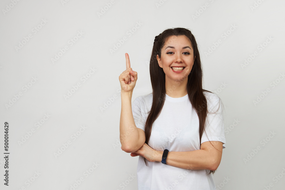 Smiling woman pointing up on white background Smiling woman pointing up on white background