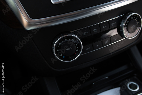 Turning on the air conditioning of a car on the climate control panel.
