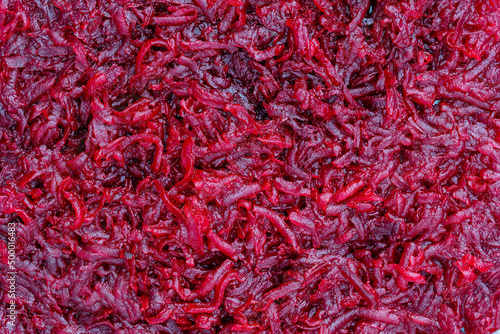 Background and texture of raw fresh grated red beetroot vegetable