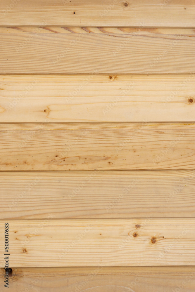 Texture of a new wooden wall. Wooden background. Wall made of new processed boards. Texture of a new wooden wall. Wooden background. Wall made of new processed boards.