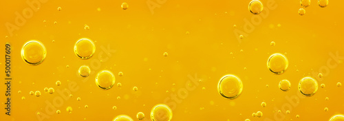 Golden liquid with air or oxygen bubbles on oil background for projects, oil, honey, beer, juice, shampoos. Oil background.