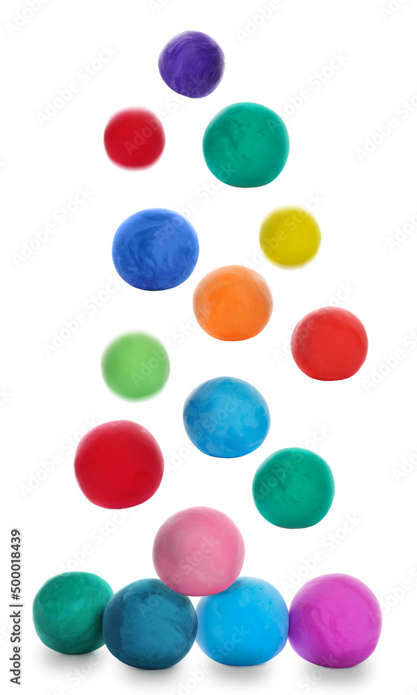 Different colorful play dough falling on white background