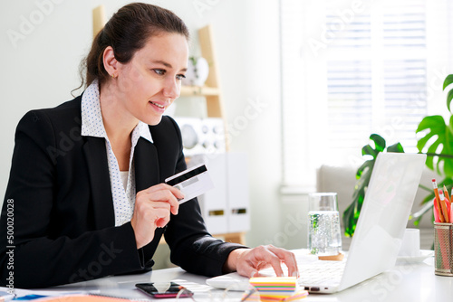 Business woman shopping online with laptop and credit card