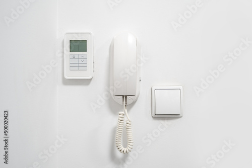 Light switch, intercom and alarm on wall in flat