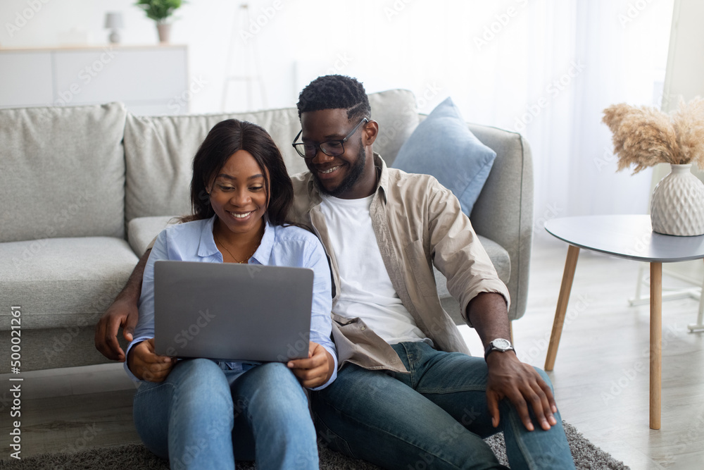 Portrait of African American couple using laptop at home Portrait of African American couple using laptop at home