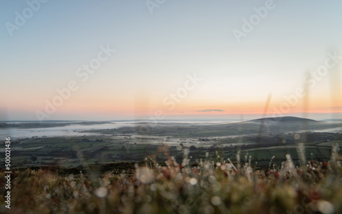 The Preseli Mountains in Pembrokeshire, Wales from Foel Drygarn at sunrise with low cloud