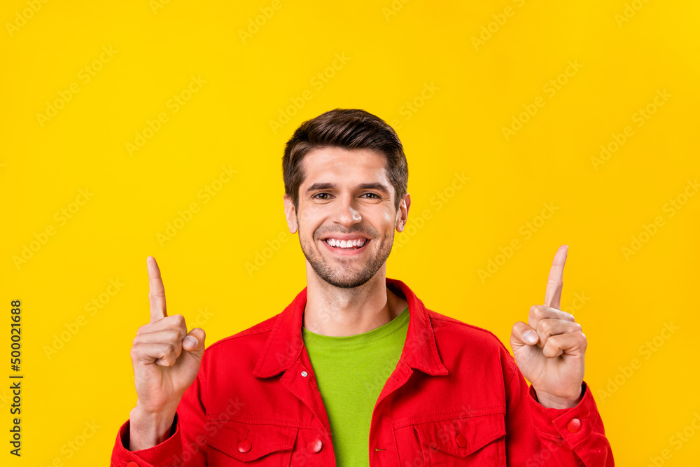 Portrait of attractive cheerful confident guy demonstrating up copy space ad idea isolated over bright yellow color background Portrait of attractive cheerful confident guy demonstrating up copy space ad idea isolated over bright yellow color background