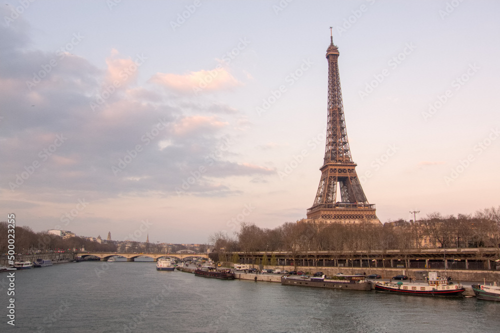 Fototapeta premium View of Eiffel Tower over the Seine in Paris at sunset, France
