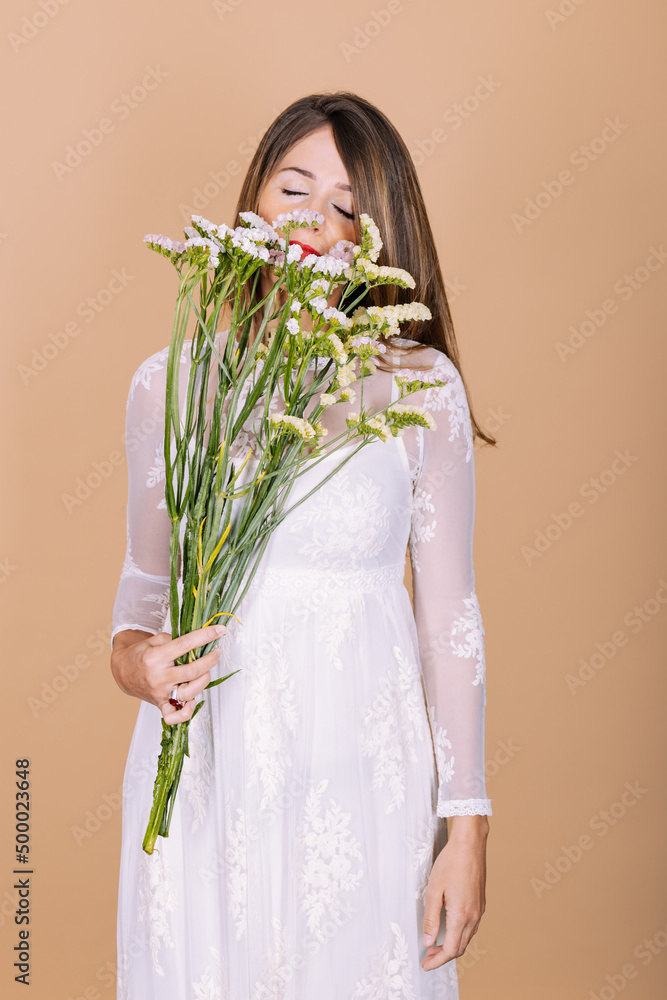 Bride in dress smelling flowers Bride in dress smelling flowers