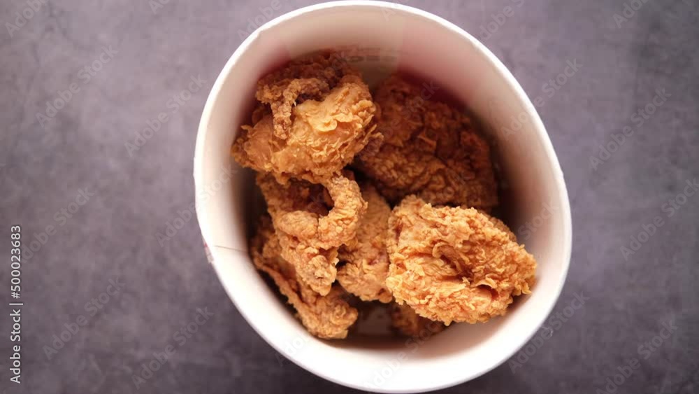 fried chicken fillets in a take away bowl on black fried chicken fillets in a take away bowl on black